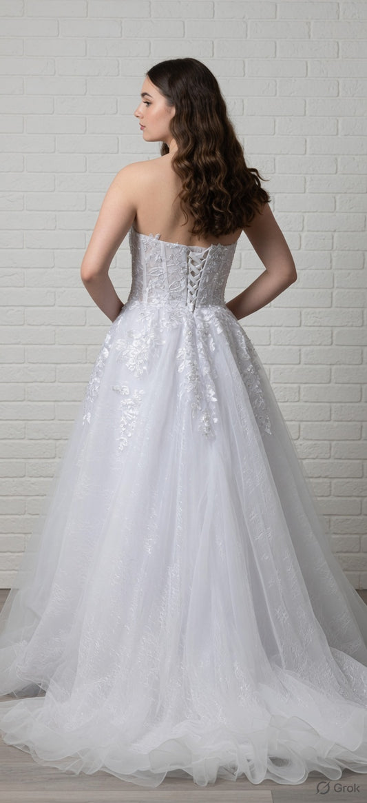 White debutante dress with a lace-up corset bodice, lace appliqué detailing, and a full  tulle skirt.