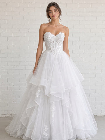 Skye V1 white floral lace debutante dress, front view on model with strapless corset and full ruffle skirt