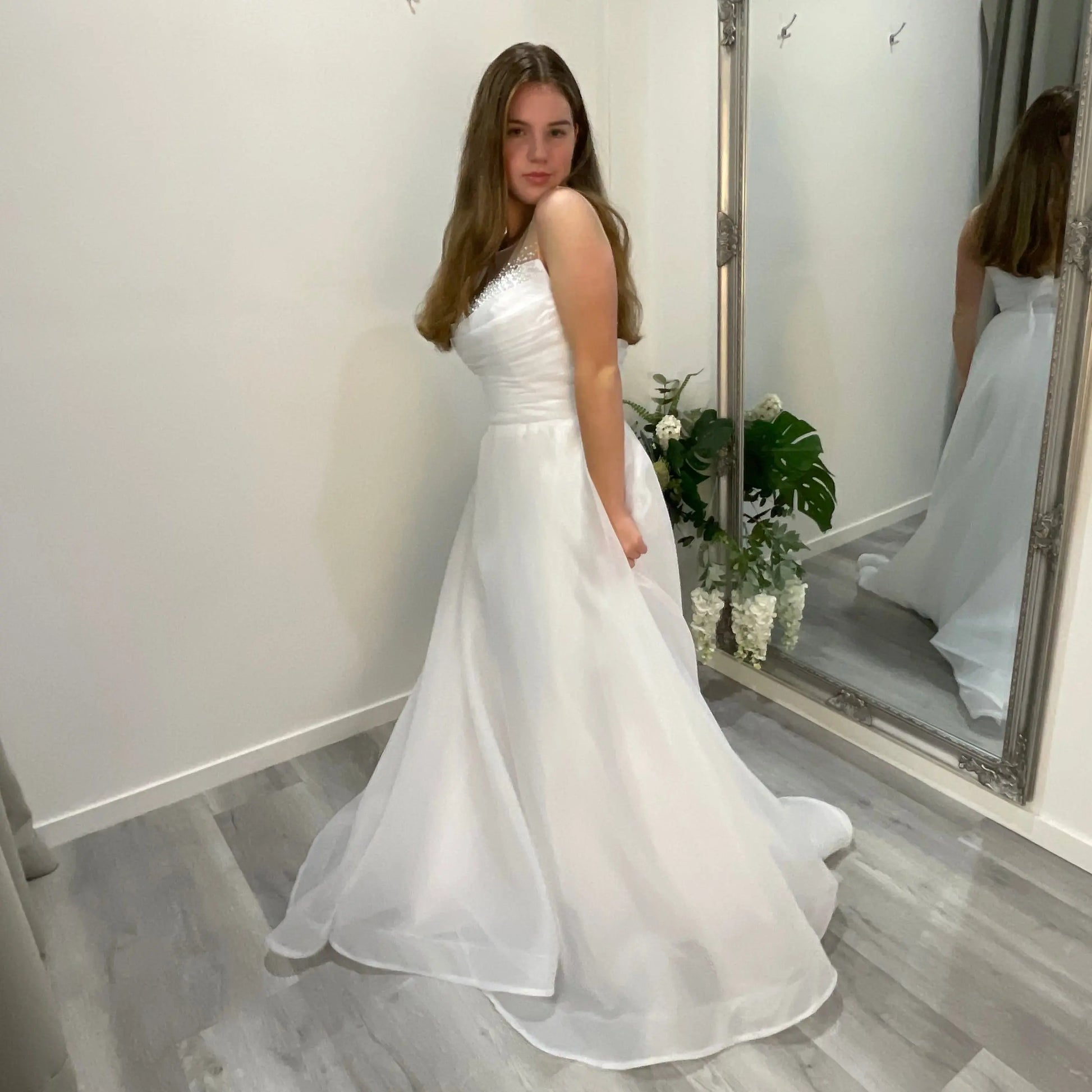 Elegant front view of Starlit Debutante Dress showcasing a beaded sweetheart neckline with Ilosian pearl detailing, complemented by organza draping and a voluminous A-line skirt.