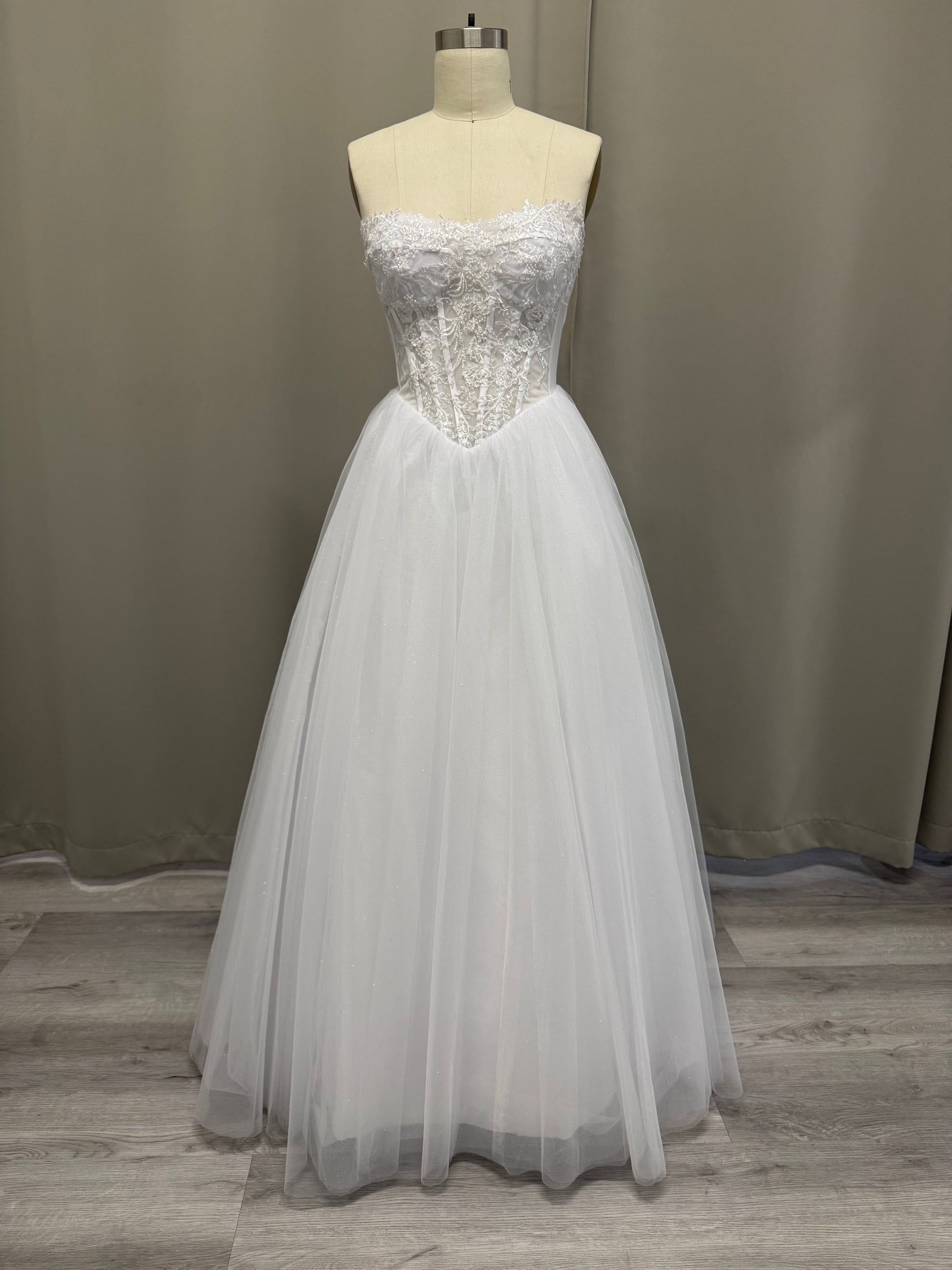 Trish V1 white debutante gown, front view on mannequin with strapless lace corset and sparkle tulle skirt