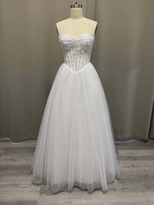 Trish V1 white debutante gown, front view on mannequin with strapless lace corset and sparkle tulle skirt