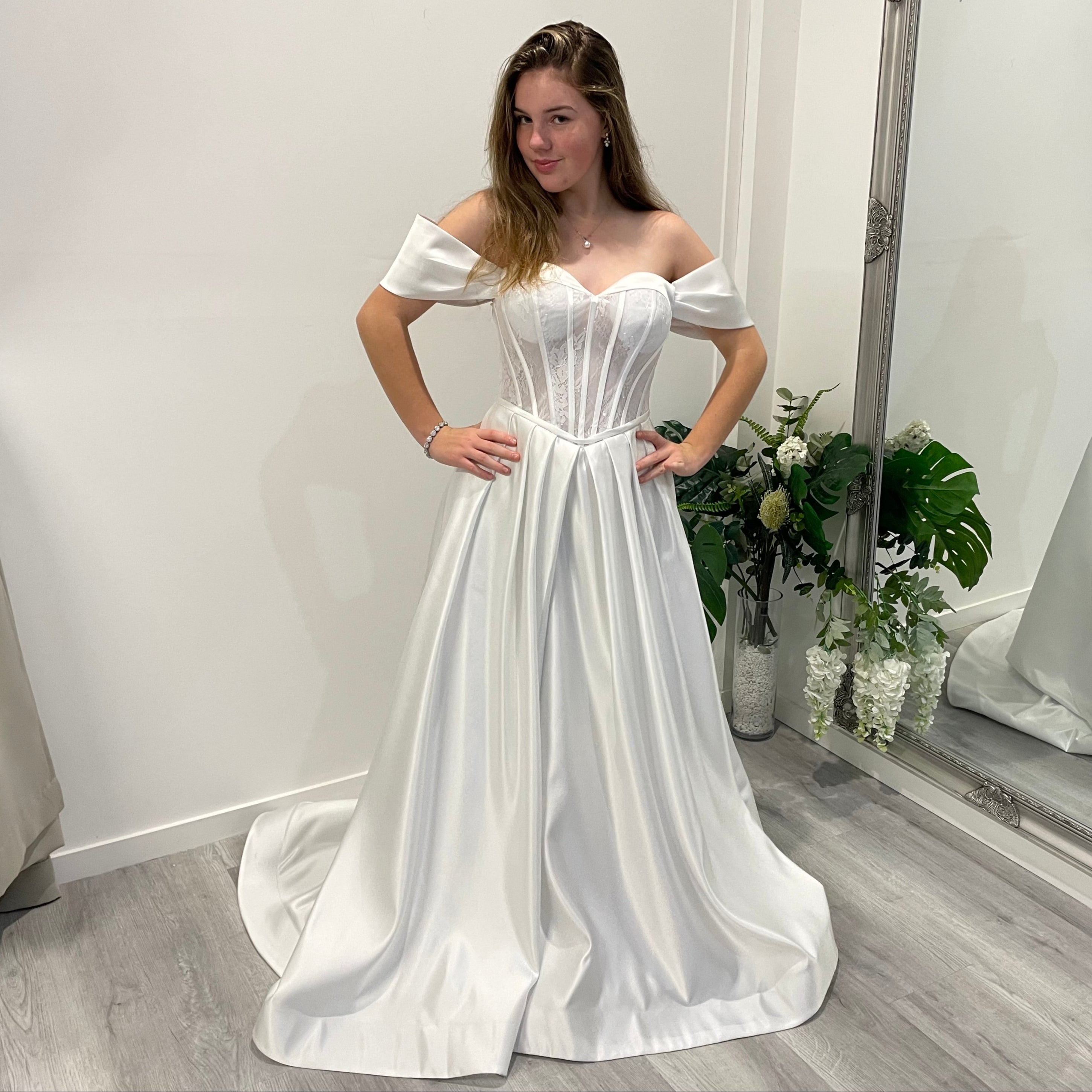 Front view of Vallorie Debutante Dress showcasing a sweetheart neckline, lace corset bodice with beaded detailing, and a satin A-line skirt with pleated waist.