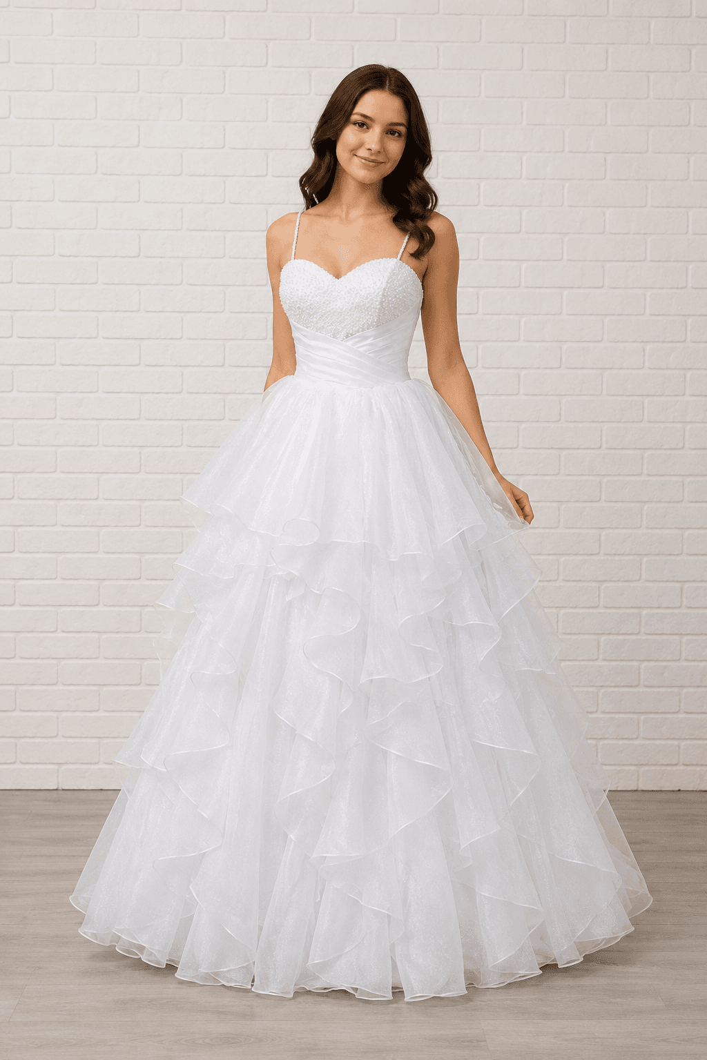 White debutante dress with a pearl beaded sweetheart bodice, delicate straps, and a layered ruffle tulle skirt.