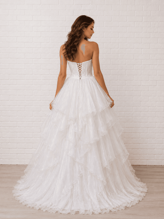 White debutante dress with a lace-up corset back and a full layered ruffle tulle skirt.