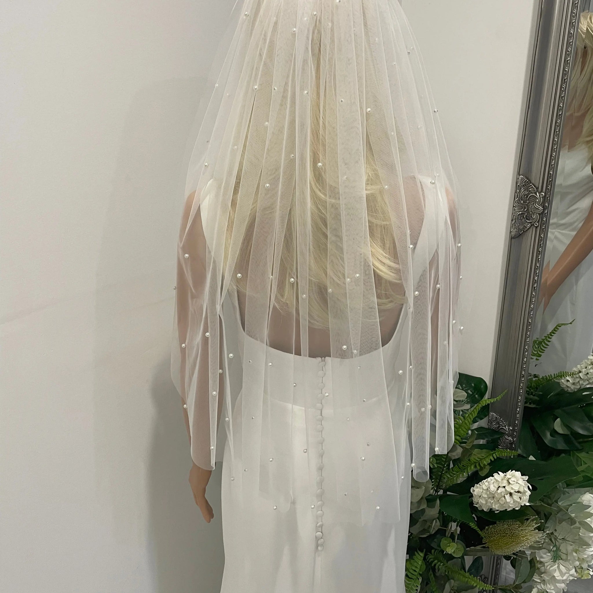 Pearl Elegance bridal veil styled with low bridal bun