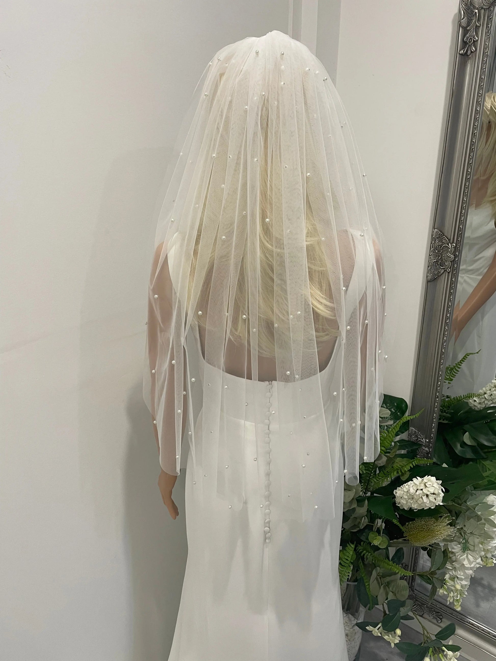 Pearl Elegance bridal veil styled with low bridal bun