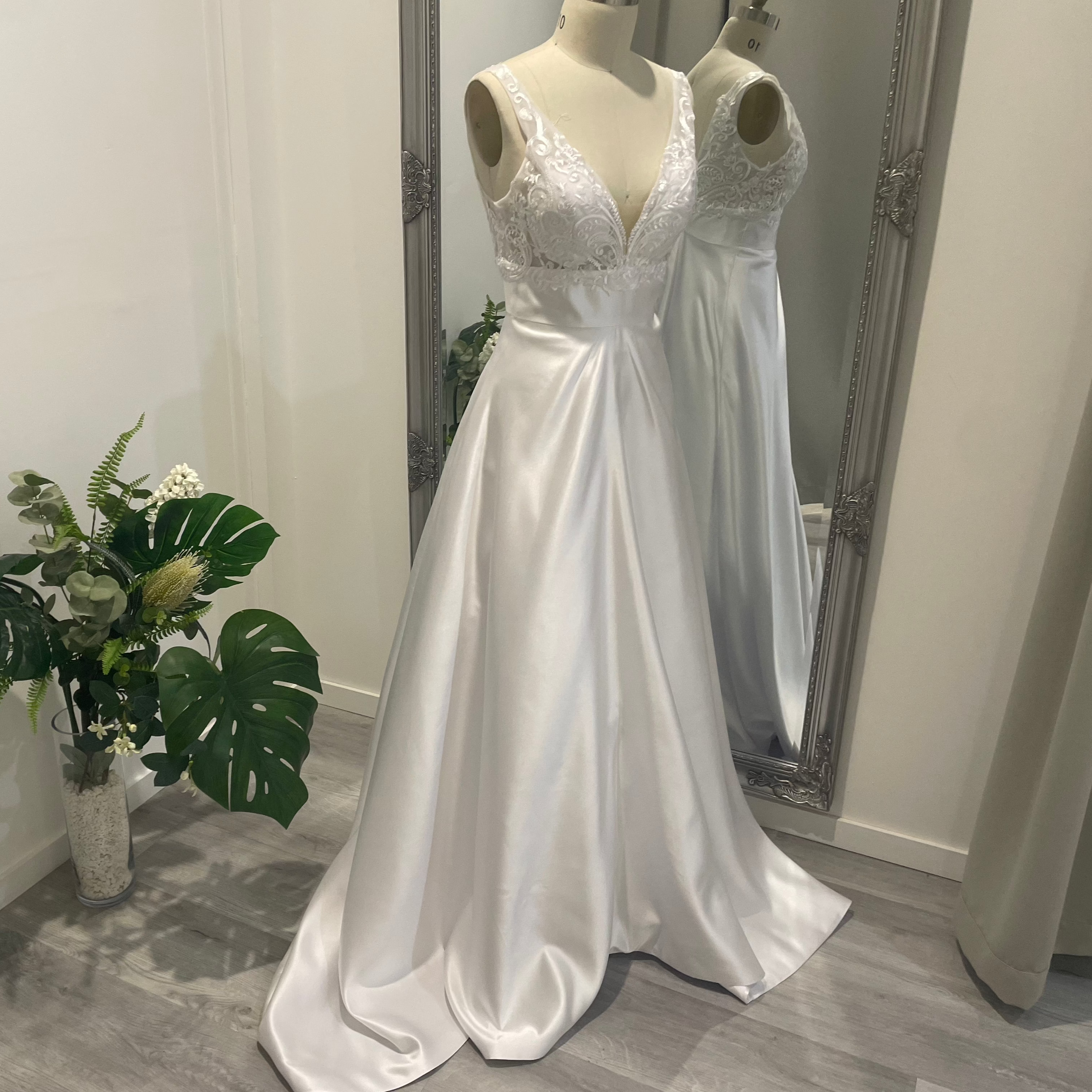 Aria Grace deb dress with lace V-neckline, defined waistband, and flowing A-line skirt