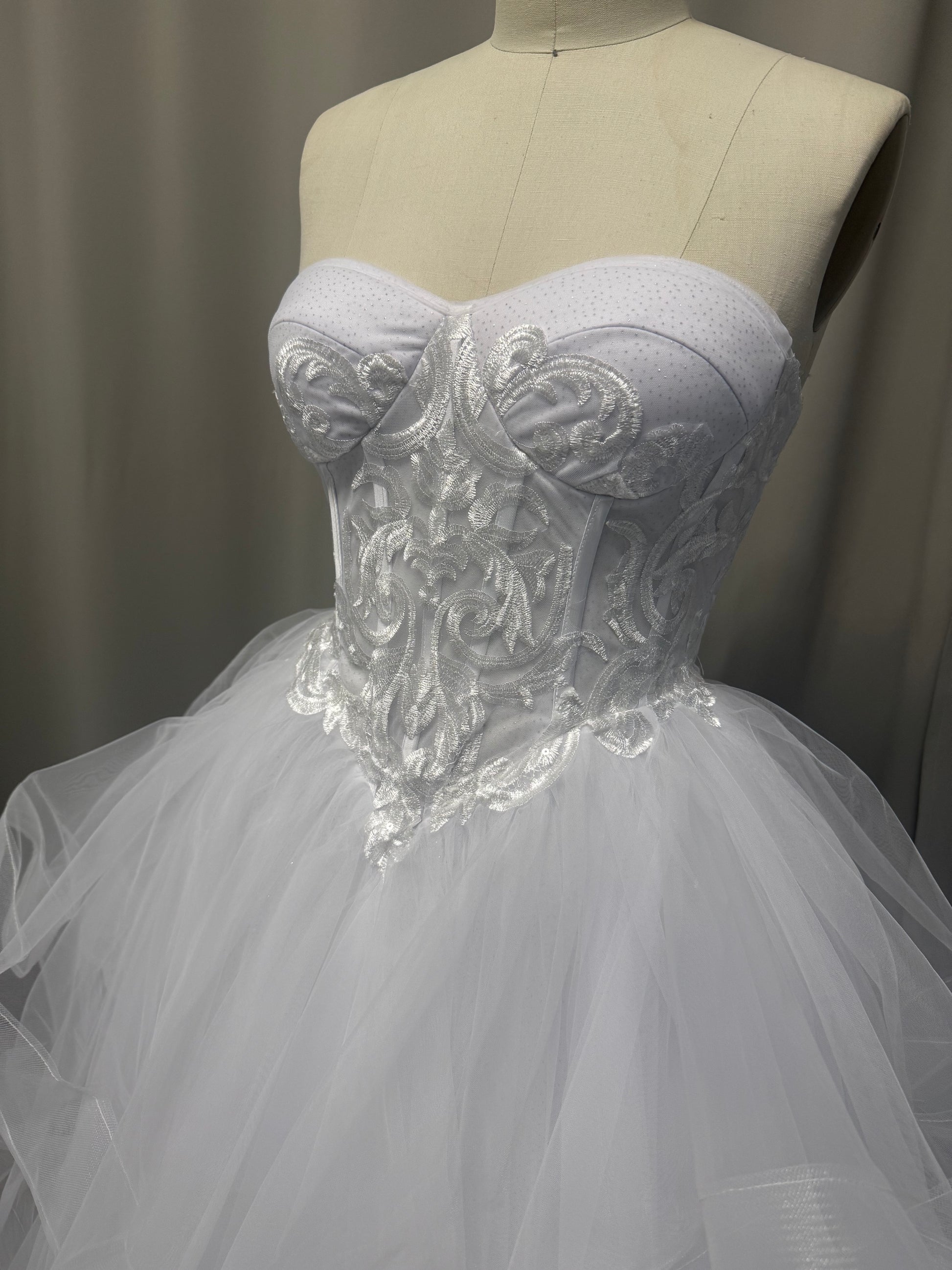 Close-up of Deanna debutante ball dress strapless sweetheart bodice with scroll embroidery and structured corset