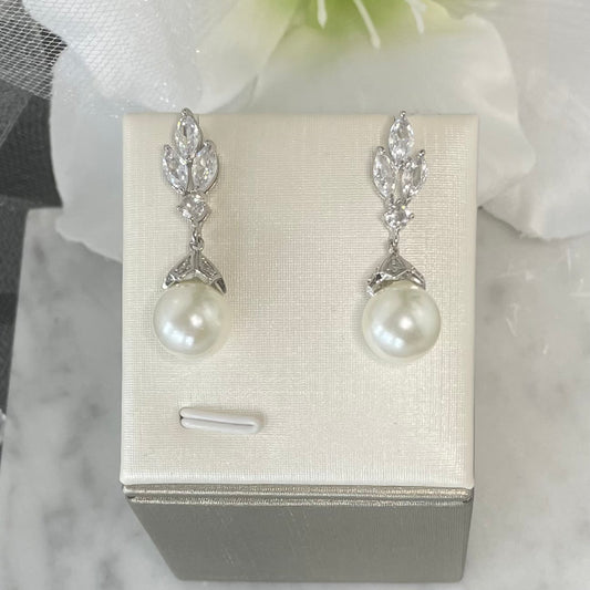 Elodie crystal pearl earrings with three leaf-like crystal design and a classic pearl drop in a secure claw setting, perfect for bridal elegance.