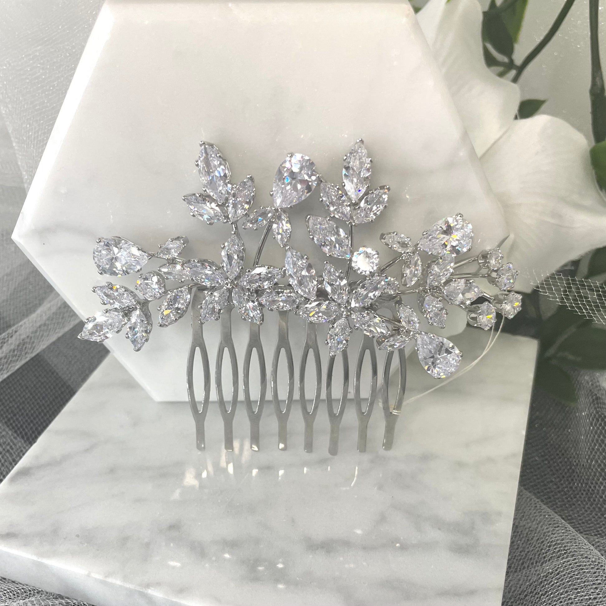Quilla Bridal Wedding Hair Comb in silver, adorned with CZ crystals in a floral design, ideal for adding elegant sophistication to any bridal hairstyle.