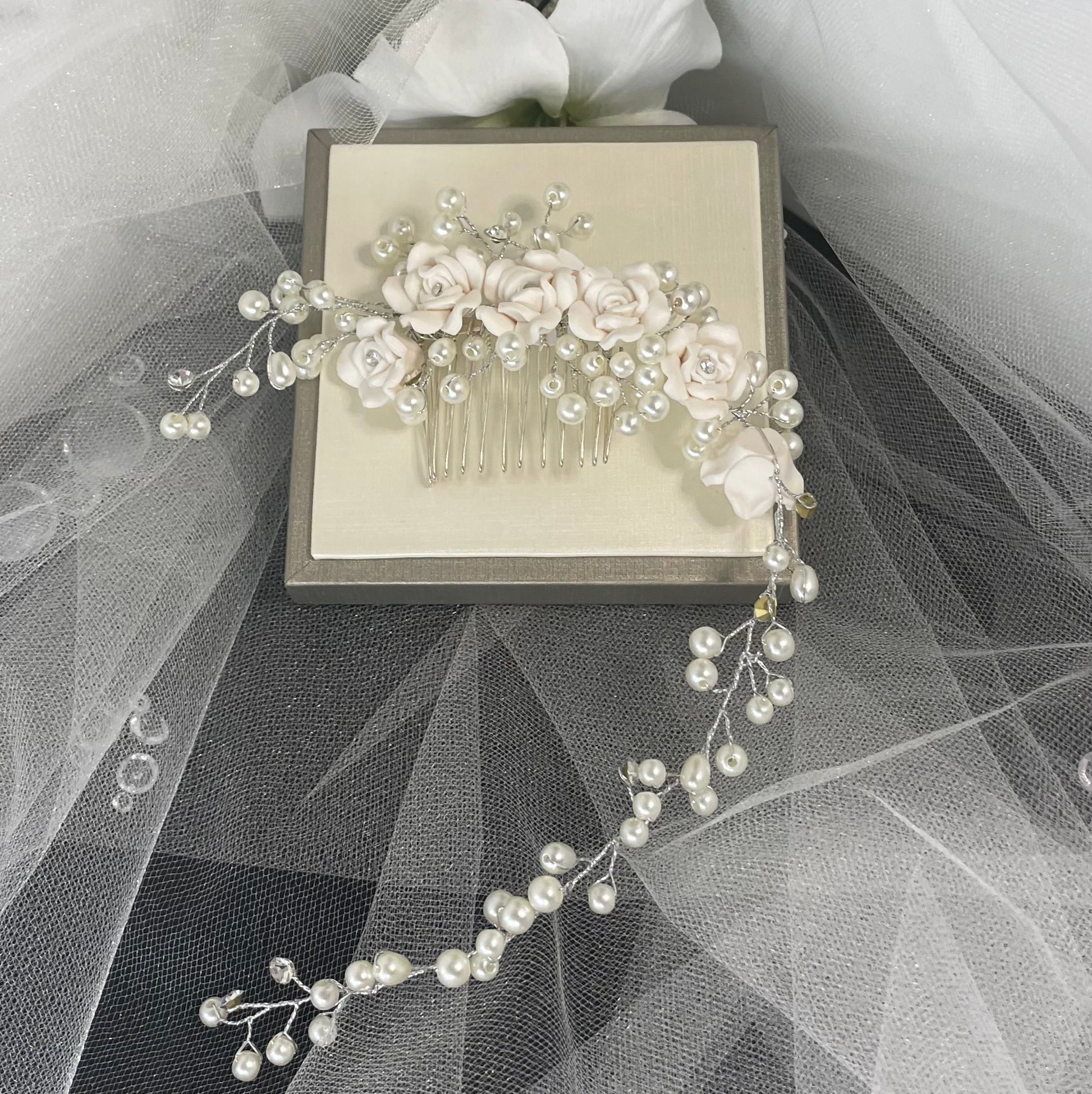 Stunning Clara Hair Vine by Divine Bridal, adorned with delicate flowers, sparkling Diamantés, and pearls, elegantly designed to enhance bridal hairstyles with sophistication.