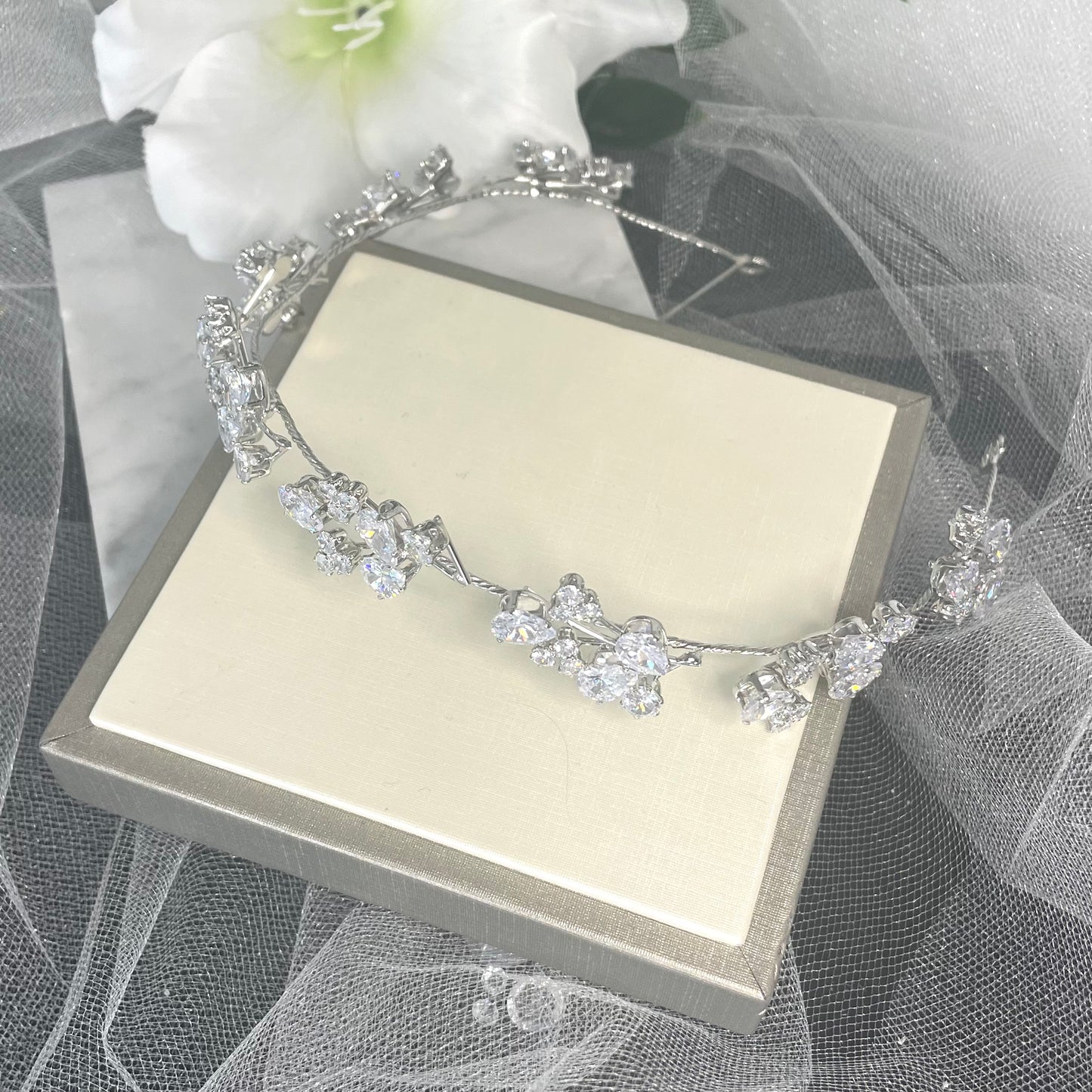 Stunning Teia Bridal Wedding Hairband with handmade silver leaves and twinkling solitaire crystals, perfect for adding a sophisticated floral touch to bridal hairstyles.