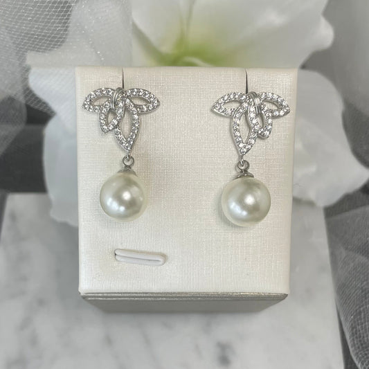 Belmont crystal pearl earrings with leaf design, varied crystal sizes, and a unique central hole, culminating in a classic pearl drop, ideal for bridal elegance.