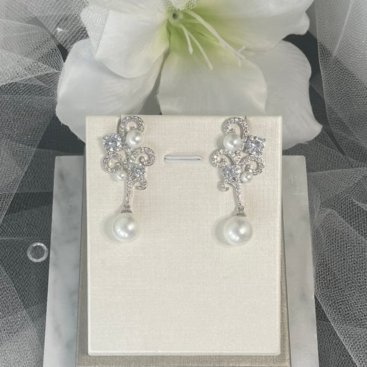 Ariana crystal pearl earrings featuring a wave-inspired pattern with a mix of small and large crystals and a prominent drop towel crystal, perfect for elegant occasions.
