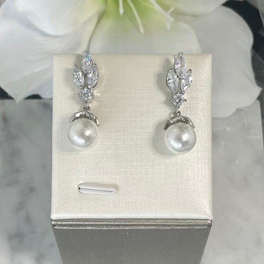 Levin crystal pearl earrings with a three-leaf design and central crystal, accented by a delicately held pearl, perfect for enhancing any bridal ensemble.
