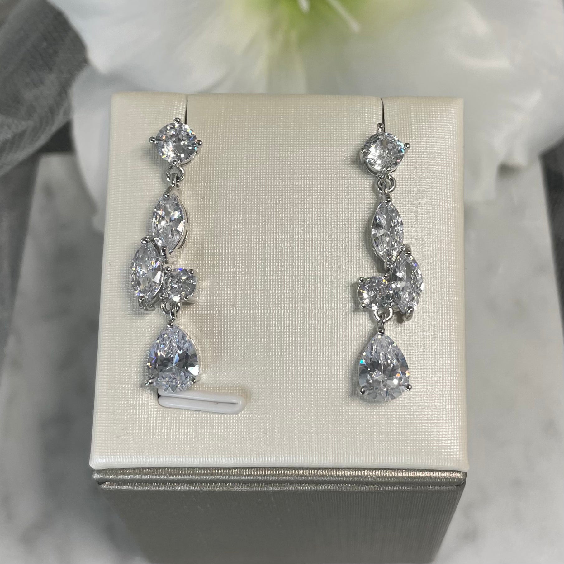 Julie cubic zirconia crystal wedding earrings featuring a sparkling round crystal, twin leaf-shaped designs, and a teardrop finish, perfect for adding sophistication to any outfit.