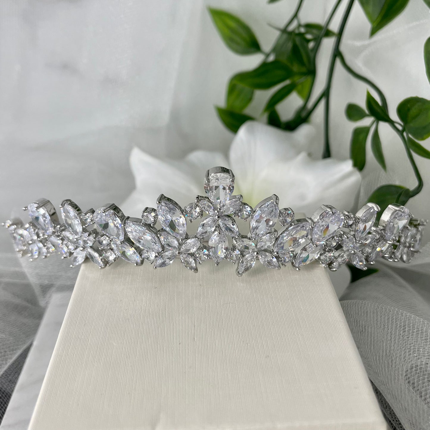 Patricia Bridal Tiara showcasing a floral and teardrop leaf design with sparkling crystals, perfect for adding luxury and elegance to any bridal look.