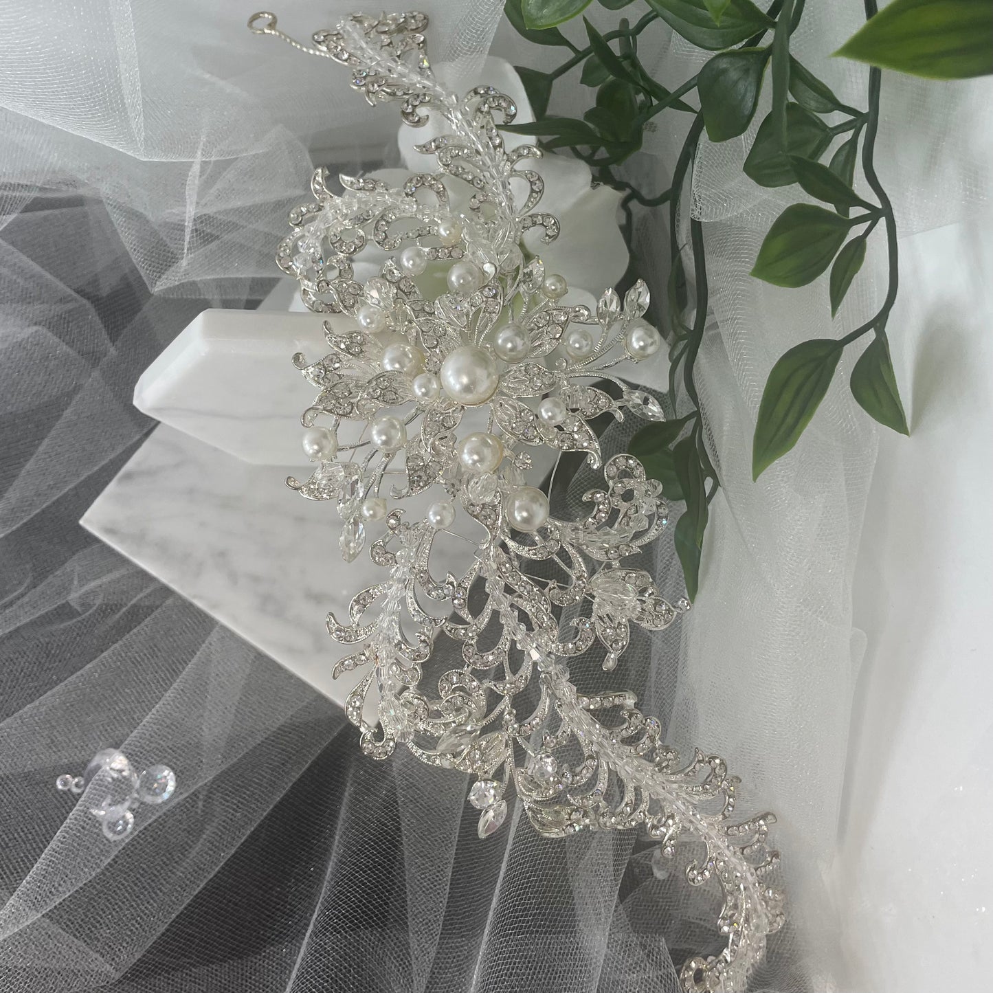 Elegant Harmony Bridal Headpiece in wave design, adorned with multi-size pearls, crystals, and Diamontes, available in silver and ivory, perfect for a statement wedding look.