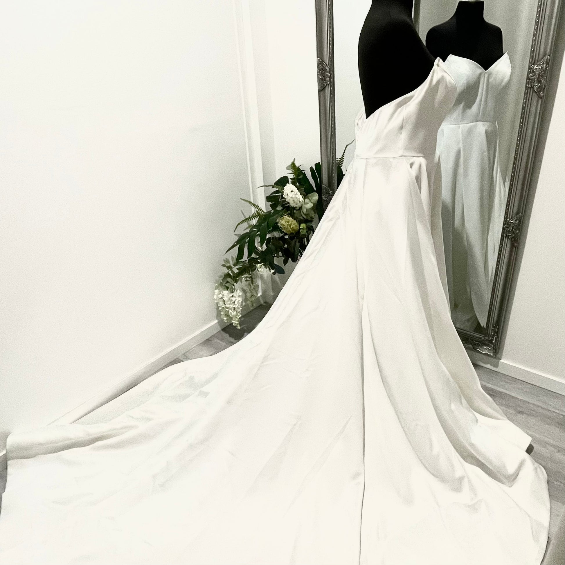 Strapless Katrin wedding gown with an A-line cut, front left split, and flowing chapel train.