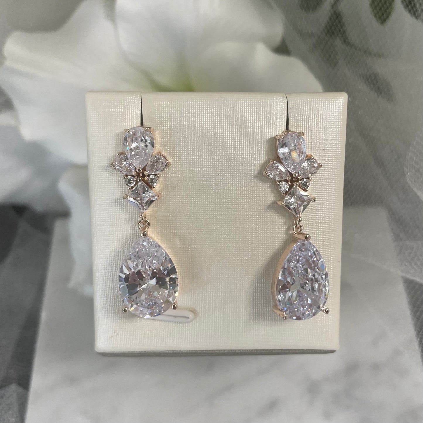 Talia Crystal Drop Bridal Earrings in Silver and Rose Gold, featuring sparkling zircon crystals, perfect for enhancing any bride's look on her wedding day.