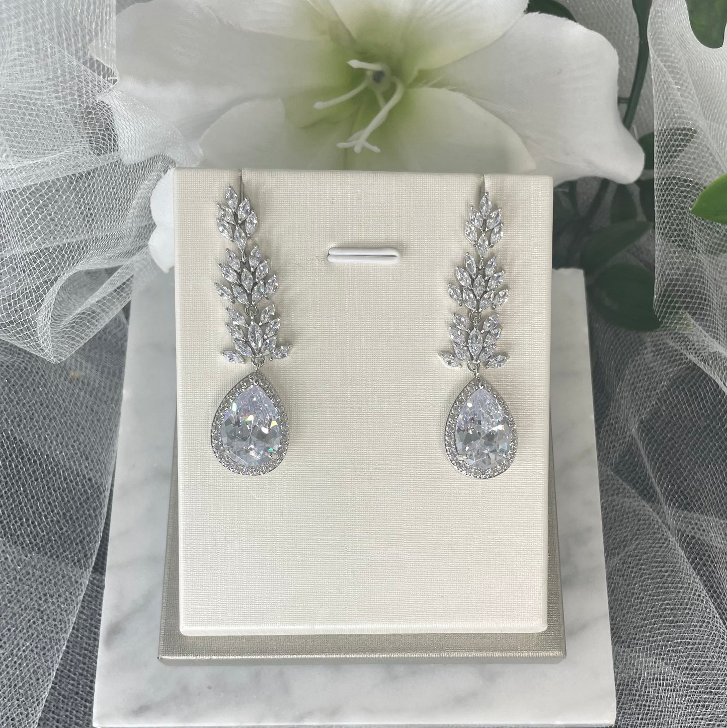 Madonna leaf-design crystal earrings with teardrop centrepiece and diamanté cubic zirconia accents.