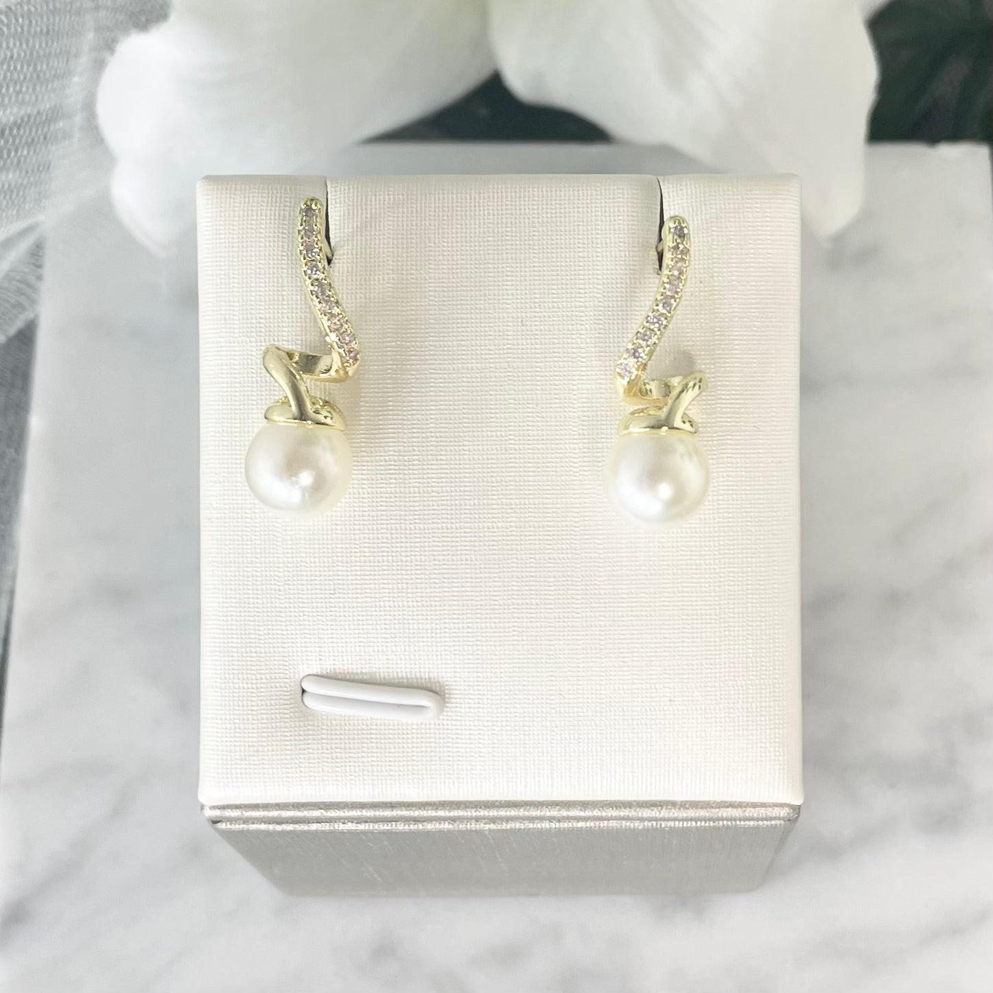 Close-up of Anastasia Pearl stud earrings showcasing the intricate zircon detailing and pearl.
