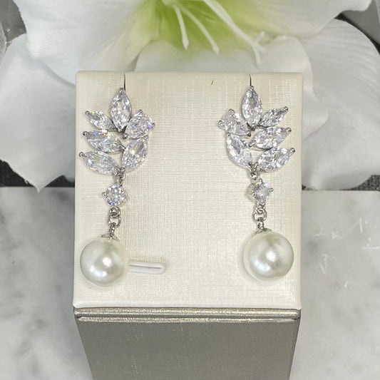 Kendra crystal pearl earrings with leaf design and round crystals, featuring a modern chain detail and a classic pearl drop, ideal for bridal elegance.
