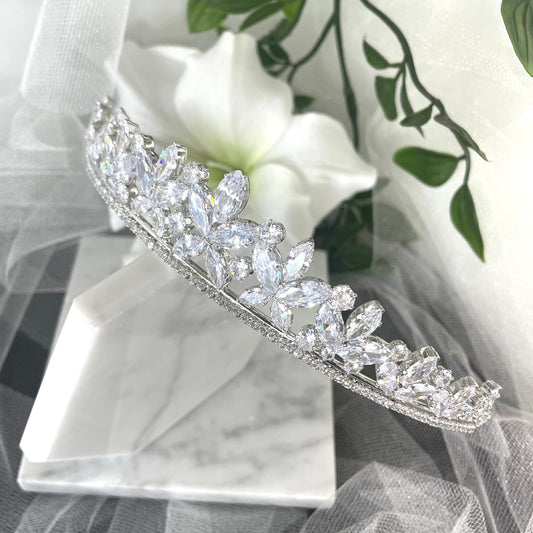 Sia Crystal Bridal Wedding Tiara in Silver, featuring sparkling cubic zirconia, floral motifs, and leaf-like crystals, designed to add a touch of elegance and luxury to any bridal look.