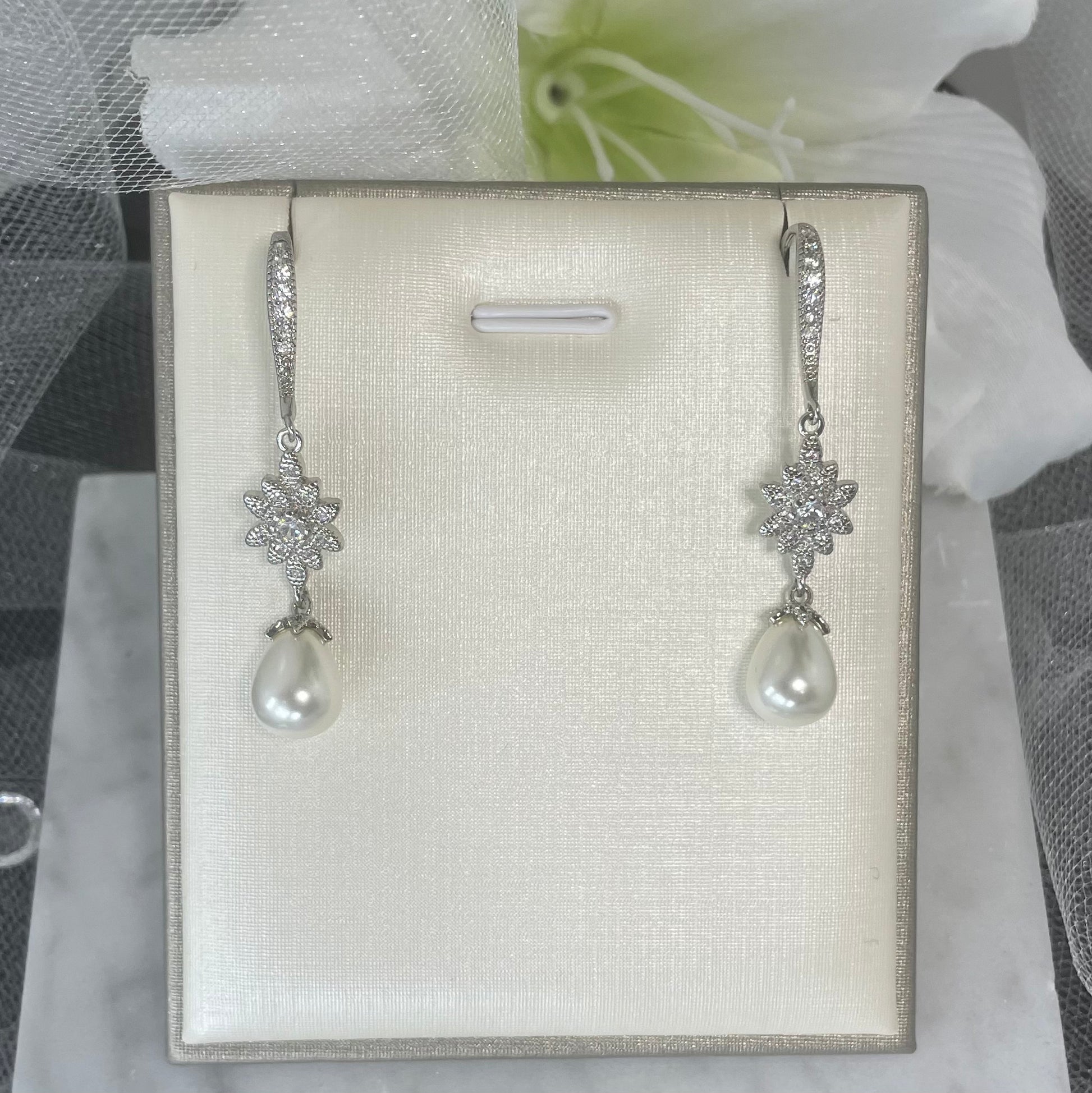 Glamorous Genevieve Crystal Pearl Earrings with cascading floral crystals and a teardrop pearl, perfect for elevating bridal looks.