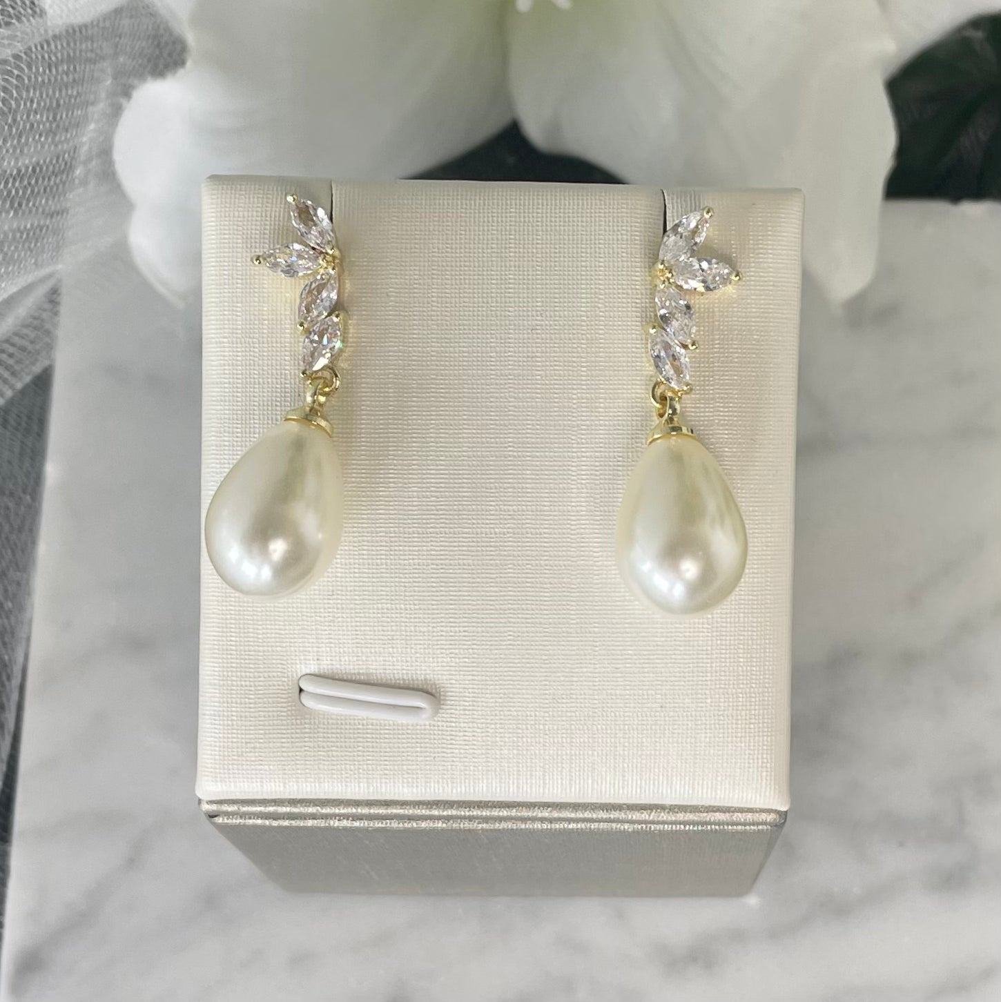 Zarina leaf-design pearl earrings with gold, diamanté, and cubic zirconia accents.