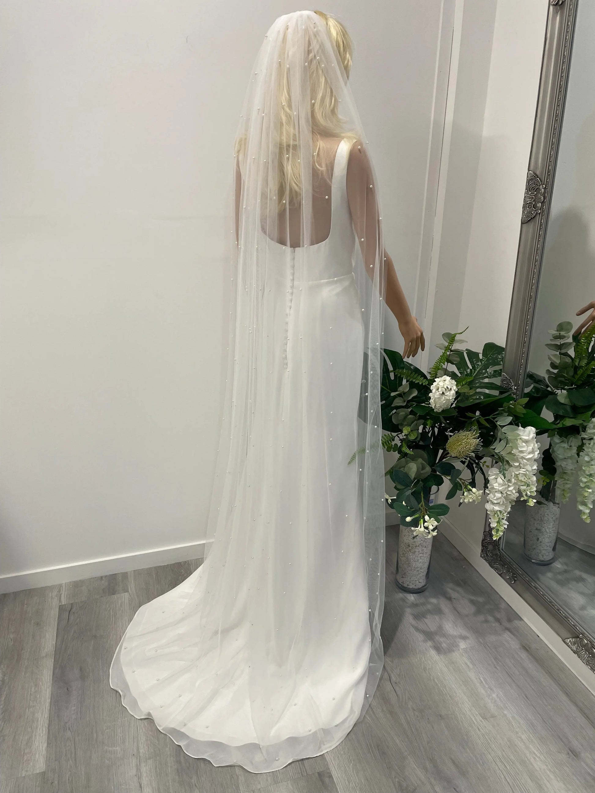 Side profile of bride wearing 2m long pearl bridal veil with scattered pearls