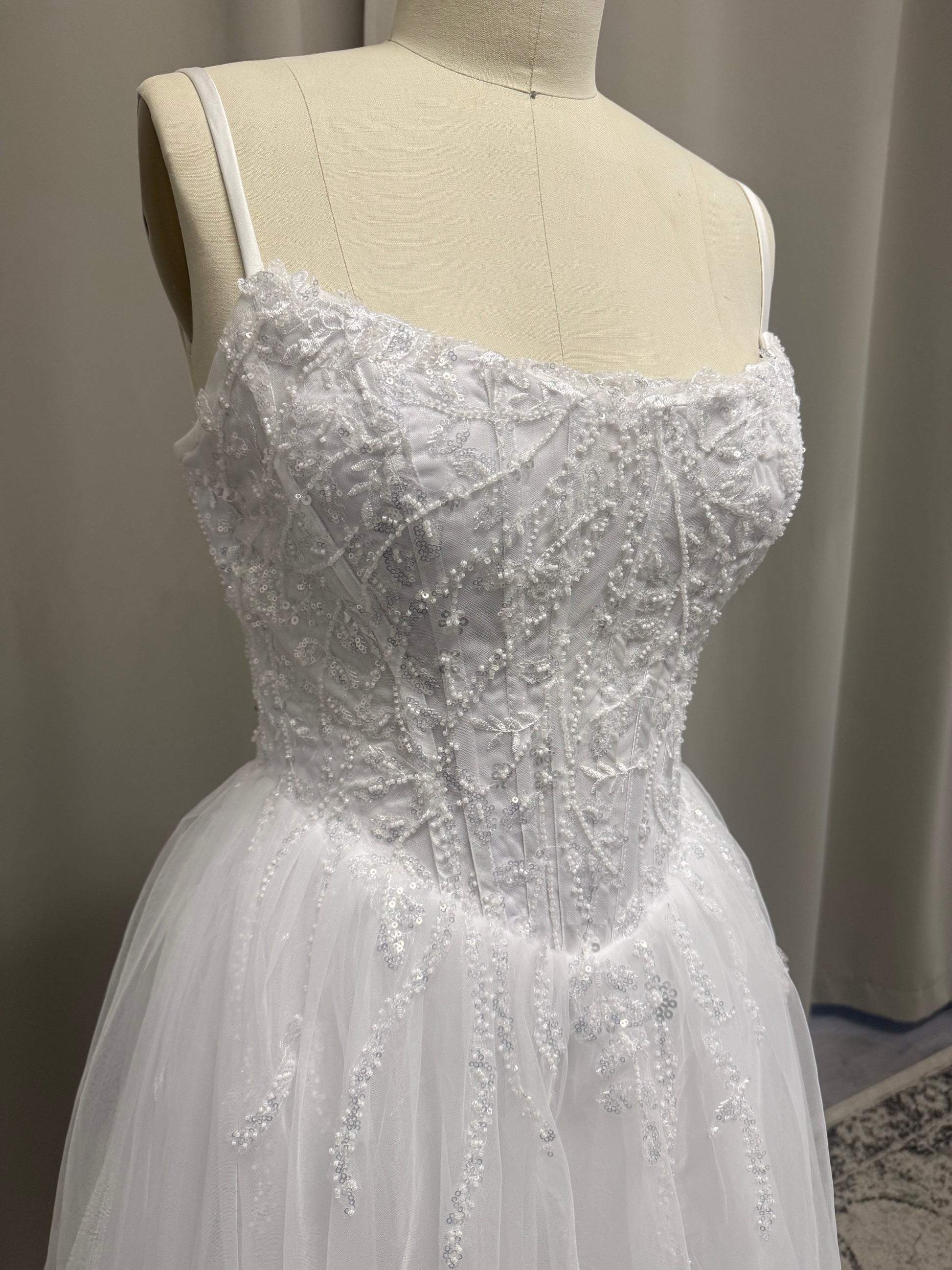 Close-up of Molly V1 spaghetti strap debutante dress beaded floral lace corset with sequin and pearl detail