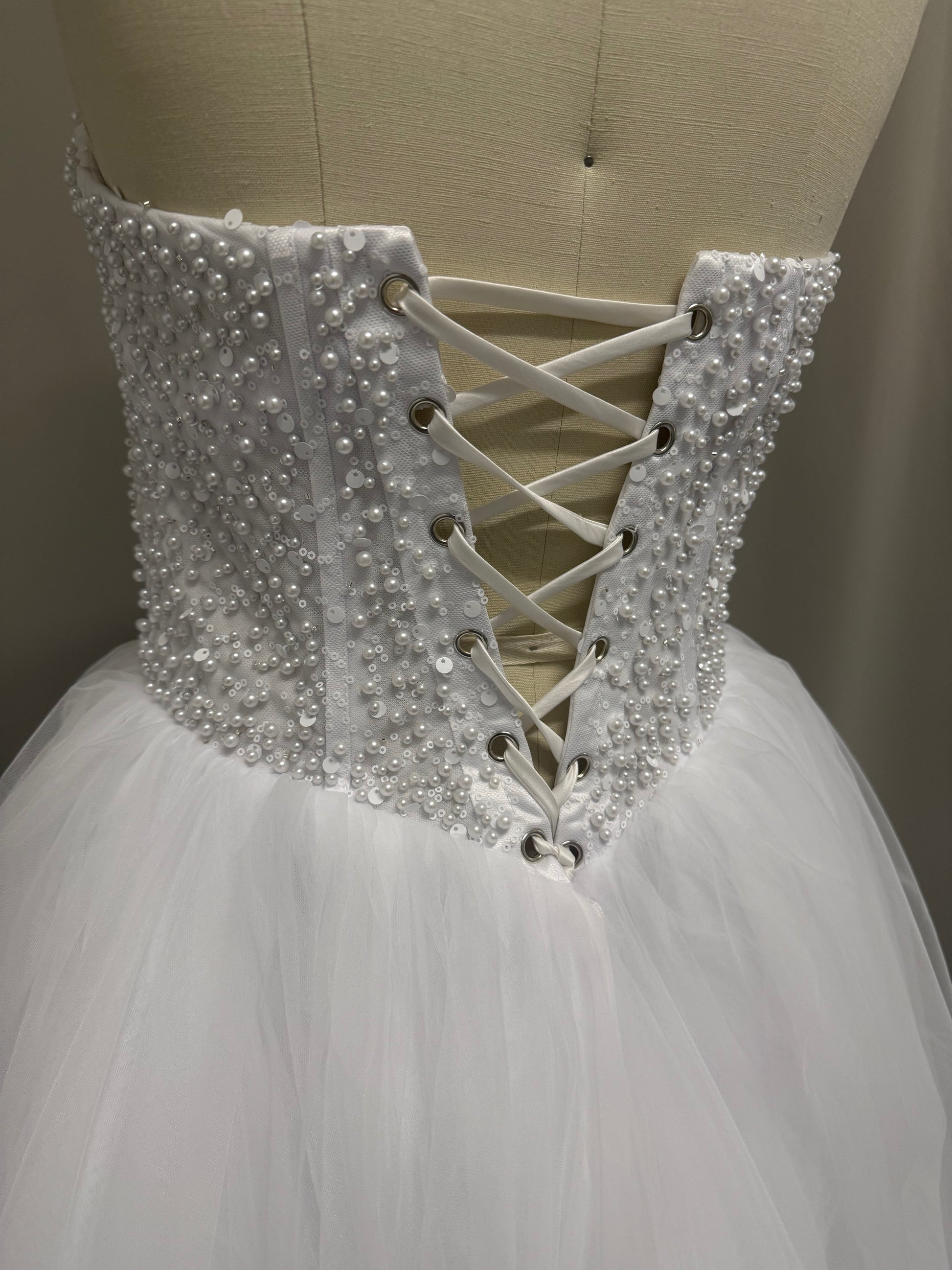 Close-up of Ophelia Debutante Ball Gown corset back showing pearl and sequin beading with lace-up detailing