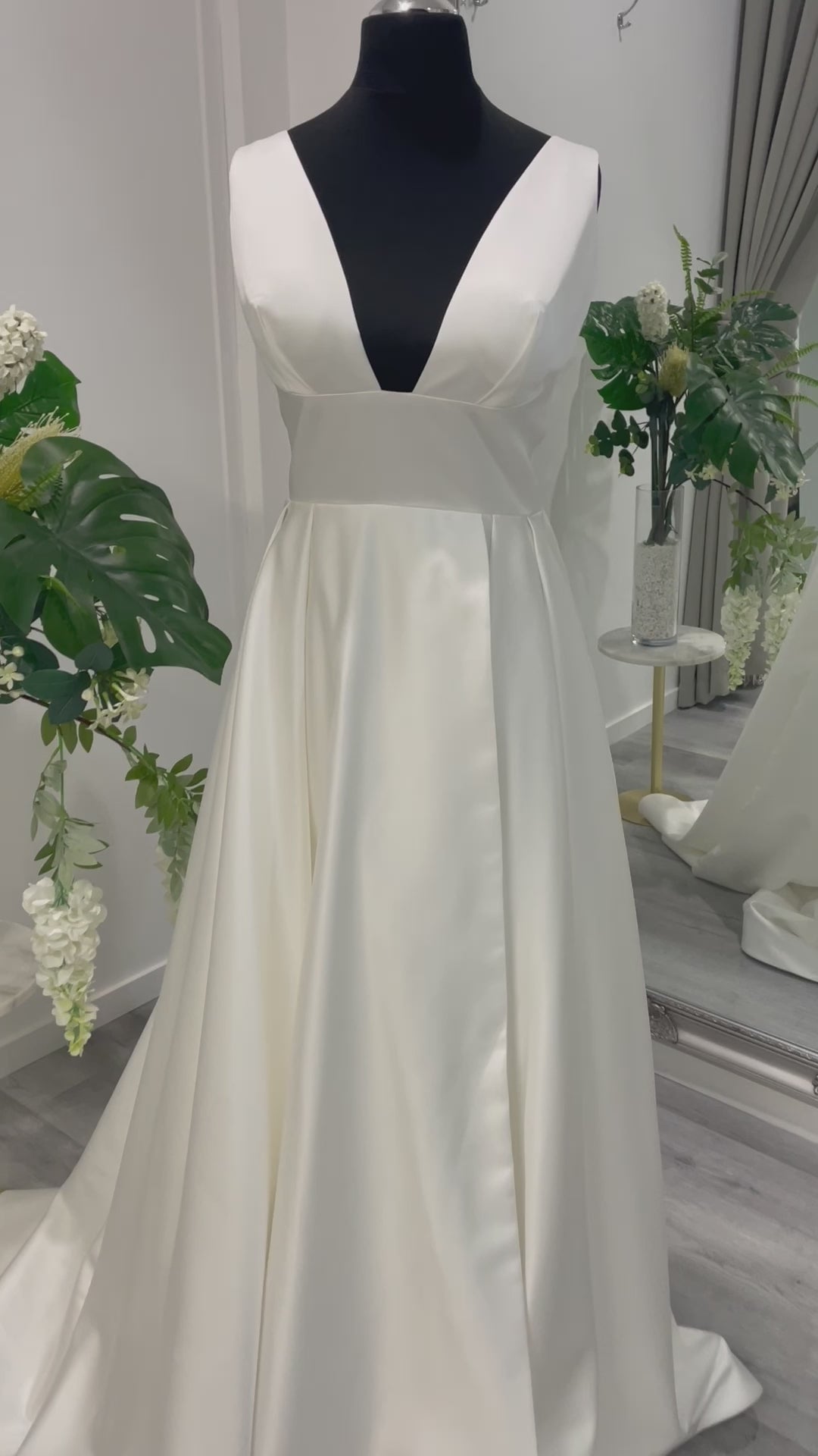 Elegant Darcy Wedding Dress with front skirt split on display at Divine Bridal.