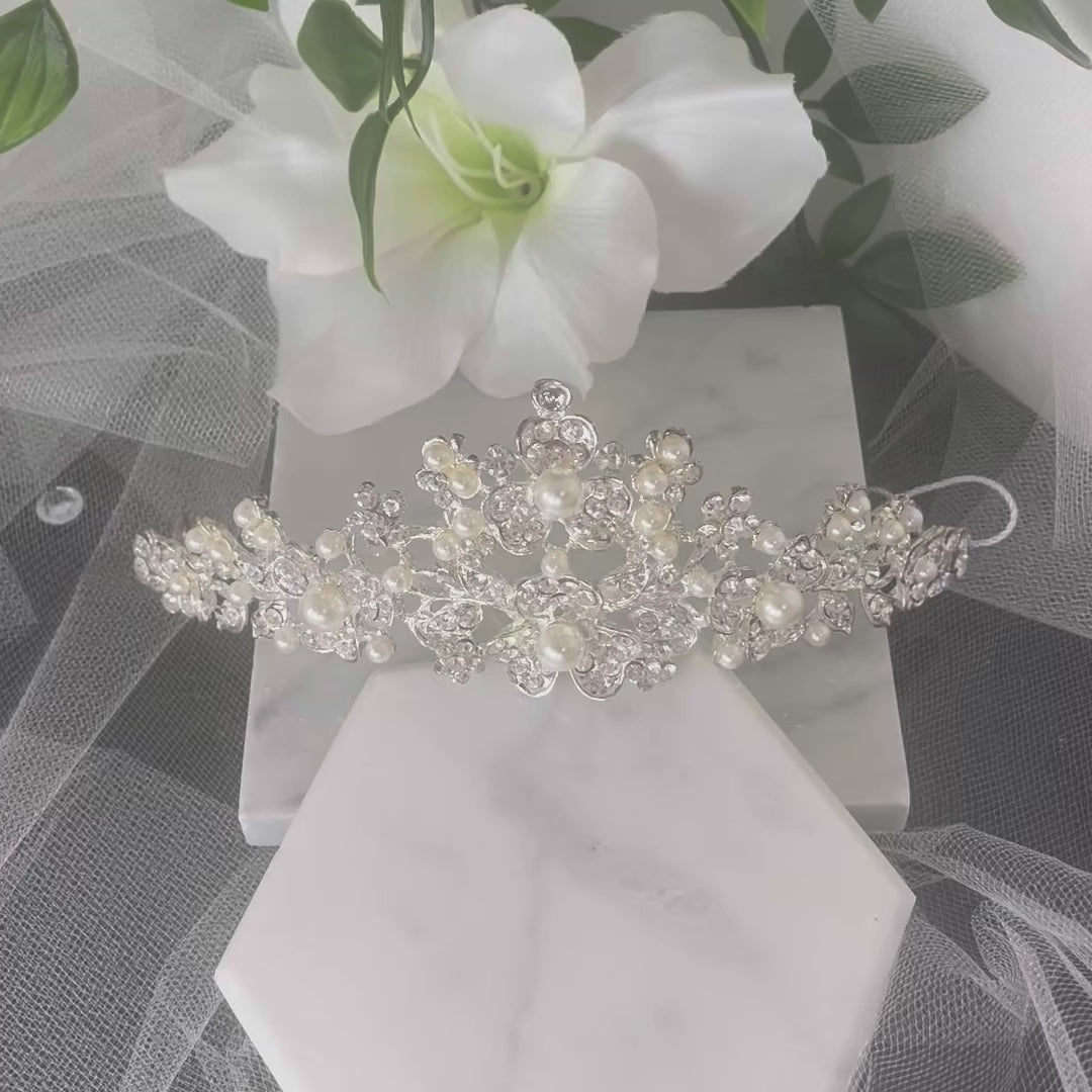 Rosita Bridal Tiara featuring a luxurious floral design adorned with sparkling Diamantés and pearls, perfect for achieving a radiant and regal wedding day look.