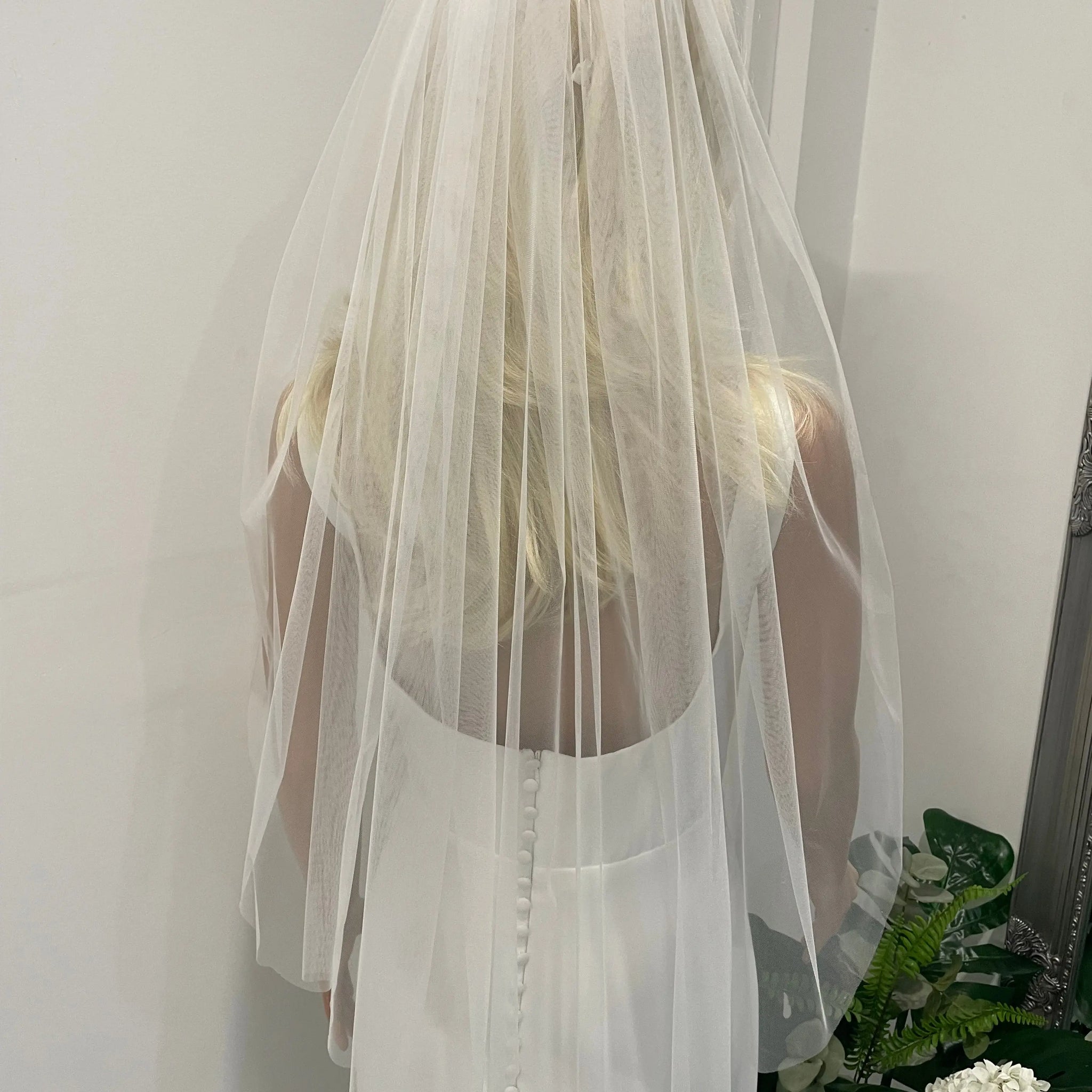 Back view of bride wearing 75cm plain soft tulle veil in light ivory