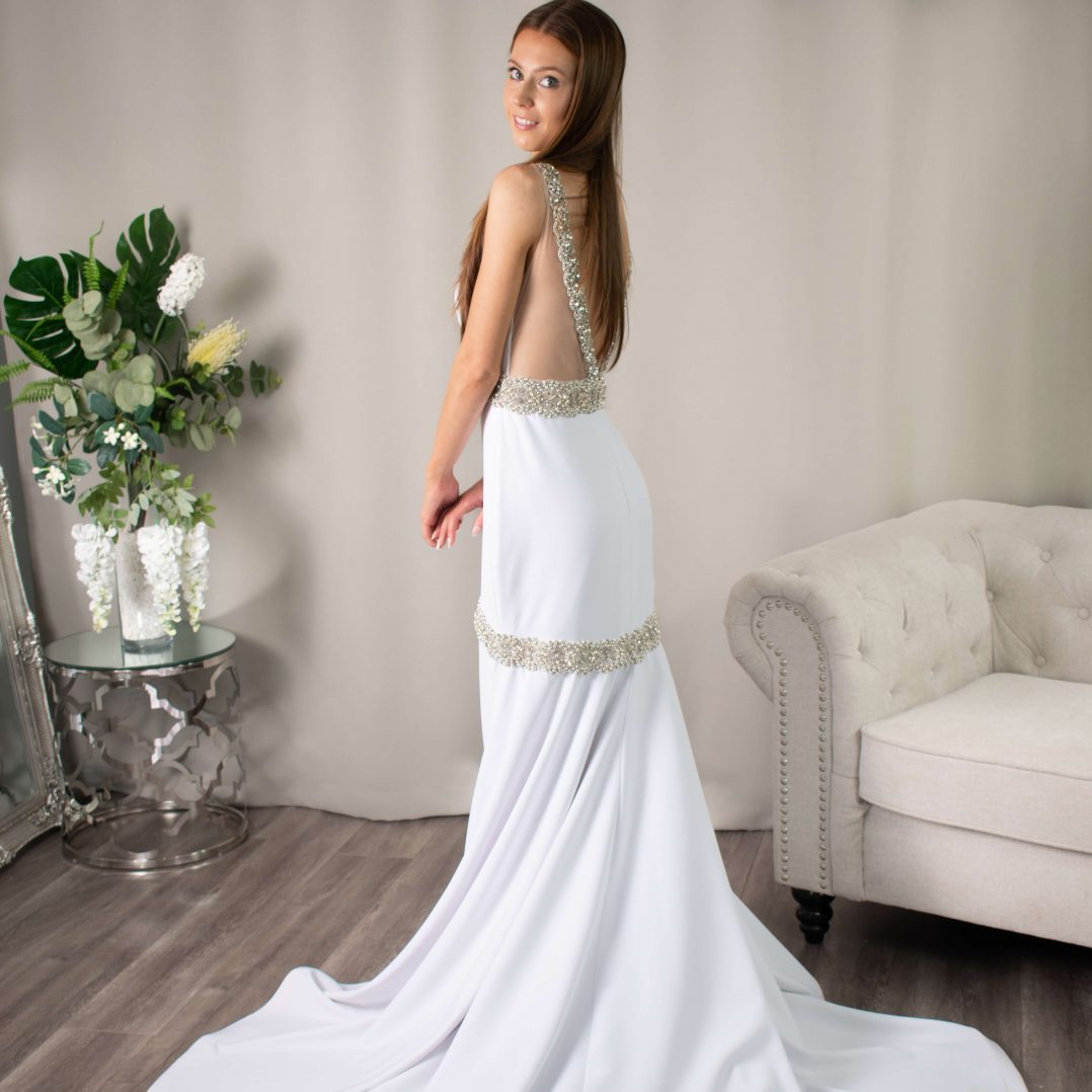 Bride in Addison Mermaid Bridal Gown showcasing high neckline, front opening, and radiant diamantés.